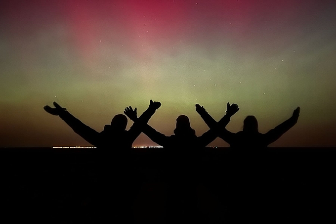 Freiwillige strecken Arme in den Himmel