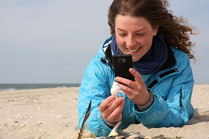 Frau mit Smartphone und Schnecke