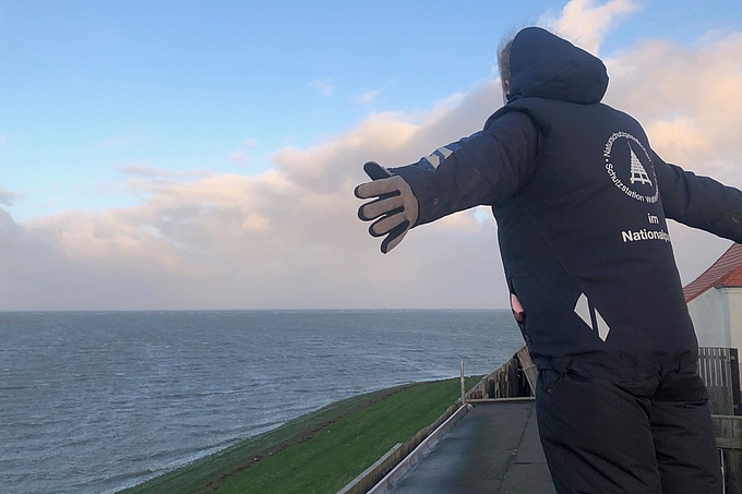 Freiwillige lehnt sich schräg in den Wind