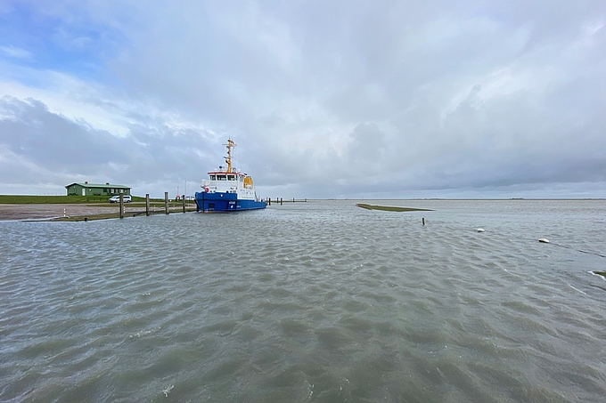 Schiff bei hohem Wasserstand im Tümlauer Hafen.